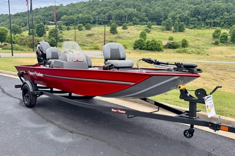 Slide: The Image of 2026 Tracker Bass Tracker Classic XL boat on trailer, parked outdoors with scenic background. - 2
