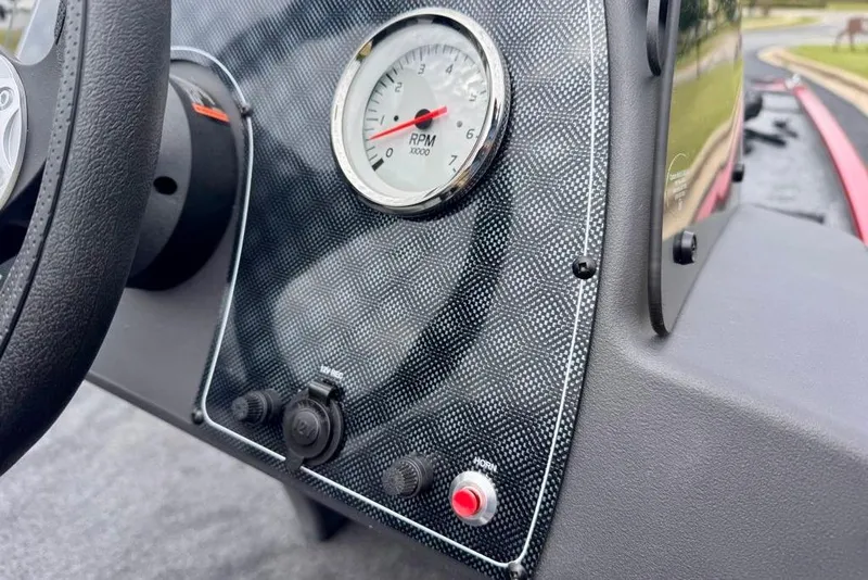 Slide: The Image of Dashboard of 2026 Tracker Bass Tracker Classic XL with RPM gauge and controls. - 12