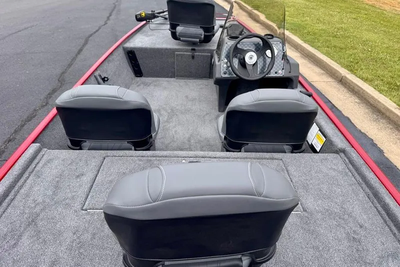Slide: The Image of 2026 Tracker Bass Tracker Classic XL boat interior with gray seating and steering console. - 8