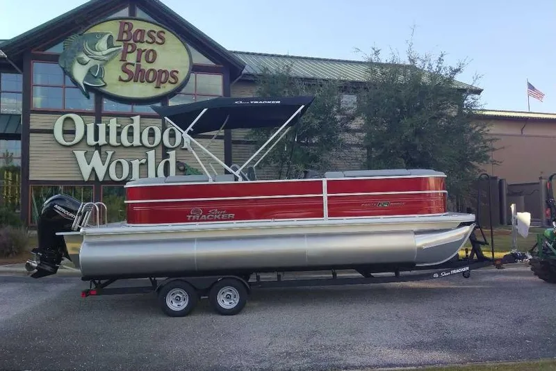The Image of 2026 Sun Tracker Party Barge 20 DLX pontoon boat outside Bass Pro Shops Outdoor World. - 0