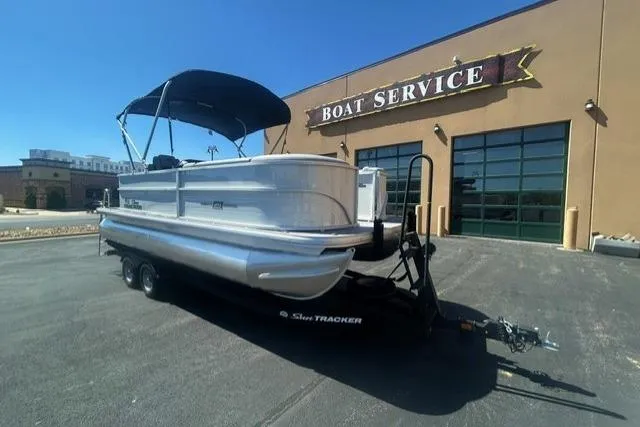 The Image of 2026 Sun Tracker Party Barge 20 DLX pontoon boat outside boat service center. - 0