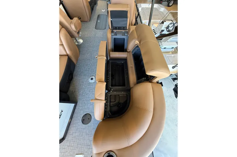 Slide: The Image of Luxurious tan seating with storage compartments in 2026 Regency 230 DL boat interior. - 8