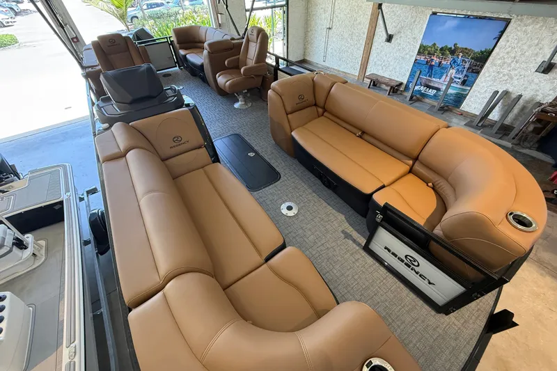 Slide: The Image of Luxurious interior of 2026 Regency 230 DL pontoon boat with tan leather seating. - 2