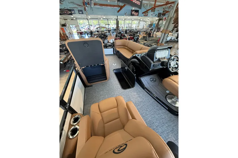 Slide: The Image of Luxurious interior of 2026 Regency 230 DL boat with tan seating and modern dashboard. - 5