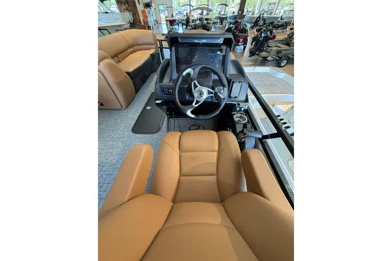 Slide: The Image of Luxurious interior of 2026 Regency 230 DL boat with tan seating and modern dashboard. - 4