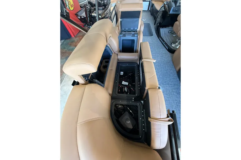 Slide: The Image of 2026 Regency 230 DL boat interior with tan leather seats and storage compartments. - 7