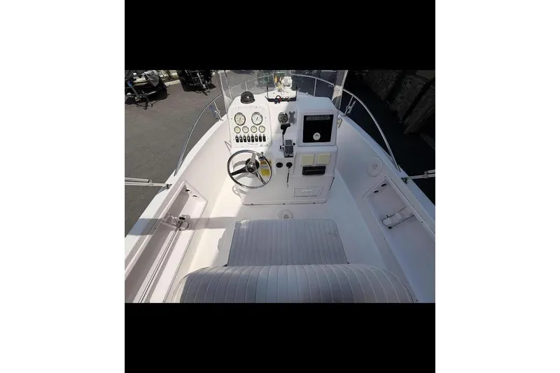 Slide: The Image of 2002 Pro-Line 19 Sport boat cockpit with steering wheel and control panel. - 2