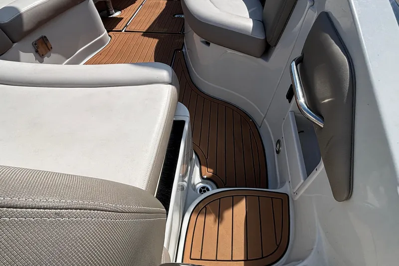 Slide: The Image of Interior of a 2020 Crownline 290 SS boat with teak flooring and cushioned seating. - 10