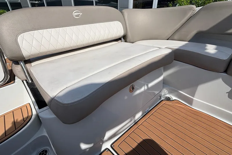 Slide: The Image of 2020 Crownline 290 SS boat interior with cushioned seating and teak-style flooring. - 13