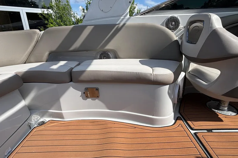 Slide: The Image of Interior seating of a 2020 Crownline 290 SS boat with cushioned seats and wood-patterned flooring. - 14