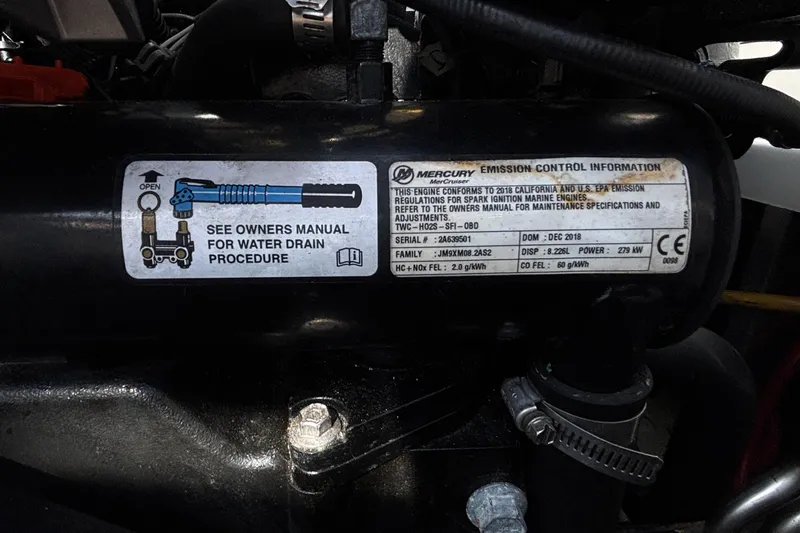 Slide: The Image of Engine label on a 2020 Crownline 290 SS, showing emission control information and water drain procedure. - 18