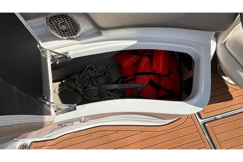 Slide: The Image of Storage compartment in 2020 Crownline 290 SS boat with life jackets and rope. - 21