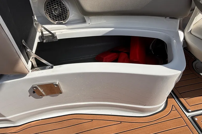 Slide: The Image of Open storage compartment on 2020 Crownline 290 SS boat with visible life jackets. - 22