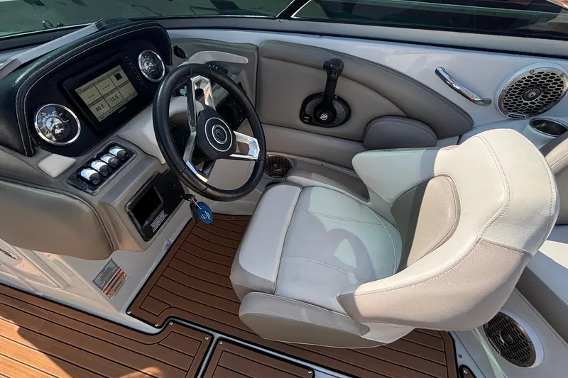 Slide: The Image of 2020 Crownline 290 SS boat interior with steering wheel and dashboard controls. - 23