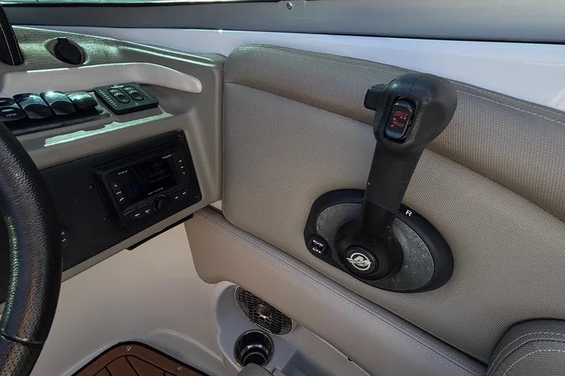 Slide: The Image of Interior controls of a 2020 Crownline 290 SS boat, featuring steering and throttle. - 26