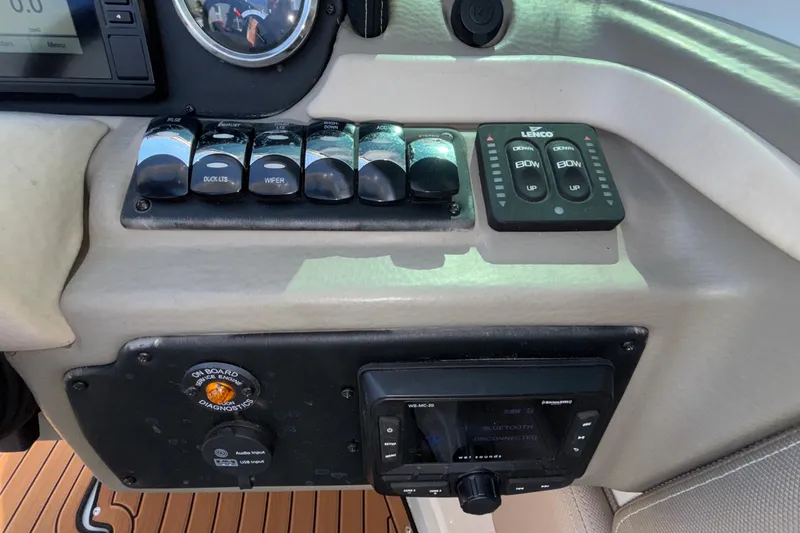 Slide: The Image of Control panel of a 2020 Crownline 290 SS boat with switches and gauges. - 29