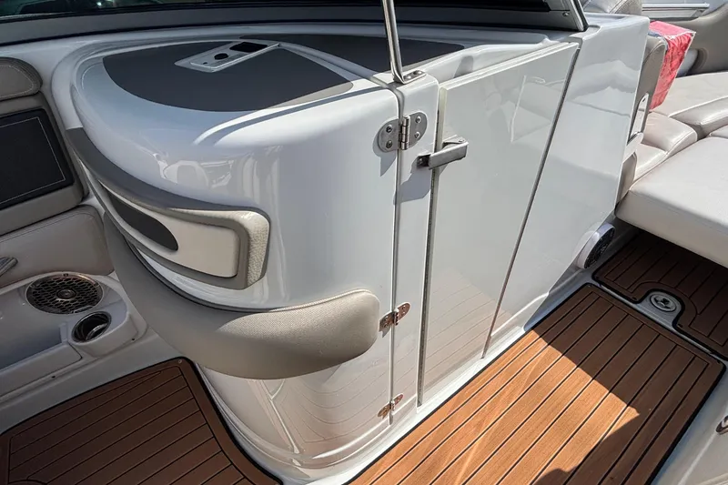 Slide: The Image of 2020 Crownline 290 SS boat interior with sleek cabinetry and wood flooring. - 40