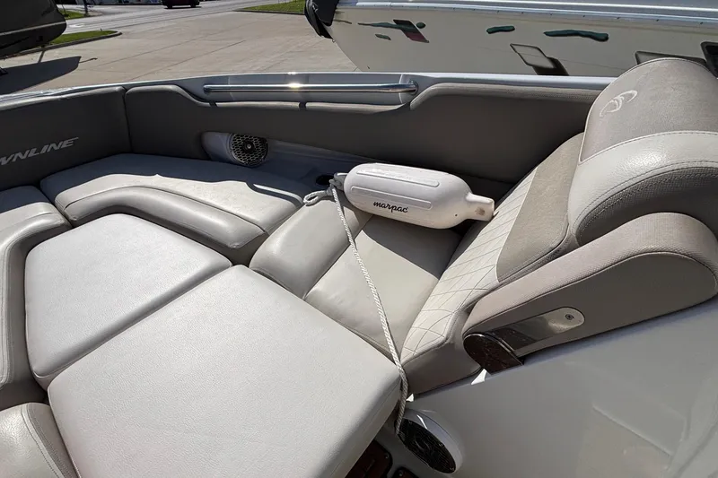 Slide: The Image of Interior seating of a 2020 Crownline 290 SS boat, featuring plush gray upholstery. - 43