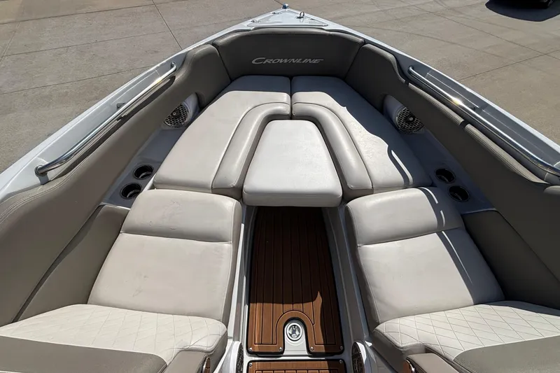 Slide: The Image of 2020 Crownline 290 SS boat interior with cushioned seating and wood flooring. - 47