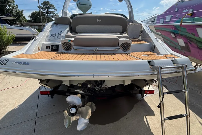 Slide: The Image of 2020 Crownline 290 SS boat with teak swim platform and ladder, docked outdoors. - 5