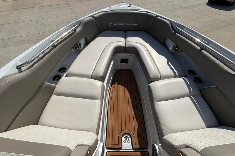 Slide: The Image of 2020 Crownline 290 SS boat interior with cushioned seating and wood flooring. - 50