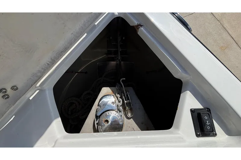 Slide: The Image of Anchor compartment of 2020 Crownline 290 SS boat with visible winch and rope. - 52