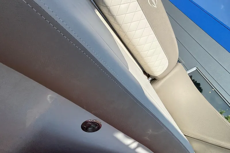 Slide: The Image of 2020 Crownline 290 SS boat interior with beige and white upholstery detail. - 55