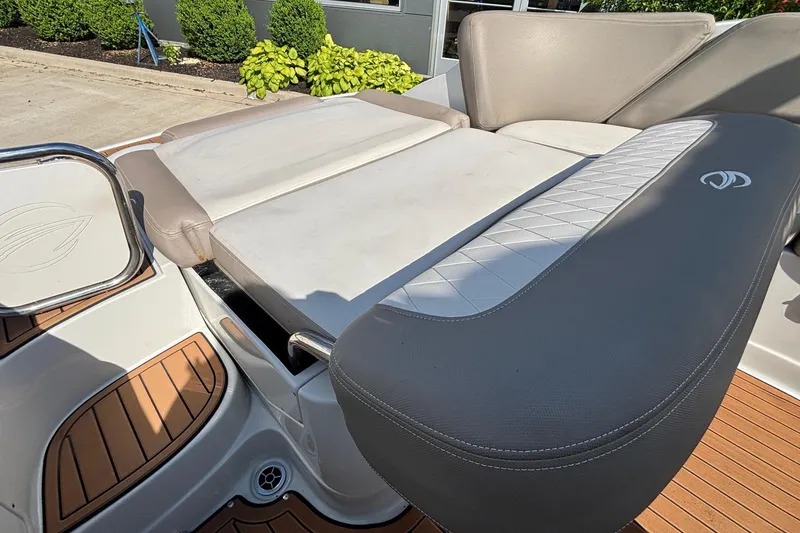 Slide: The Image of 2020 Crownline 290 SS boat interior with cushioned seating and teak flooring. - 56