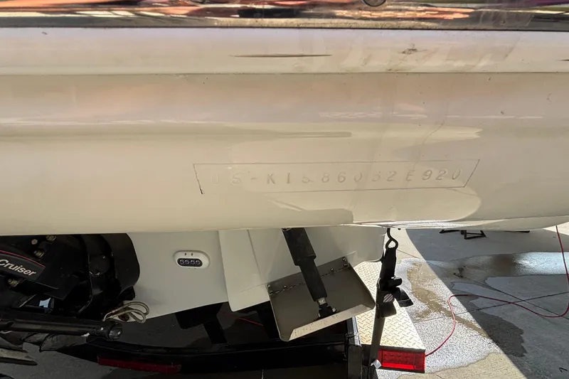 Slide: The Image of 2020 Crownline 290 SS boat hull with visible identification number and engine components. - 60