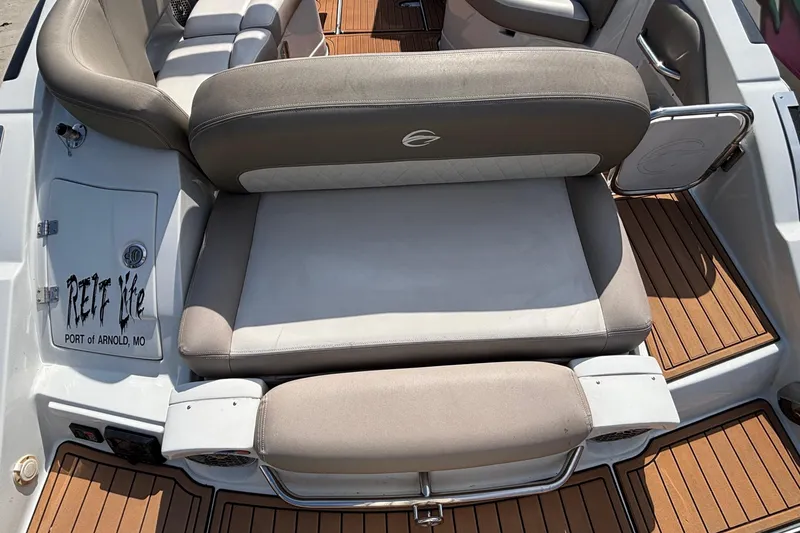 Slide: The Image of 2020 Crownline 290 SS boat interior with cushioned seating and teak flooring. - 7