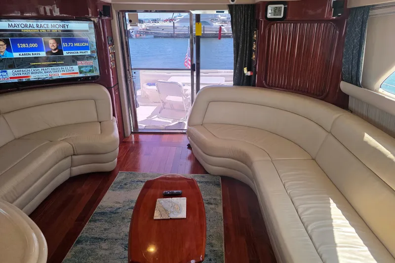 Slide: The Image of Luxurious interior of 2002 Sea Ray 560 Sedan Bridge yacht with leather seating and waterfront view. - 104