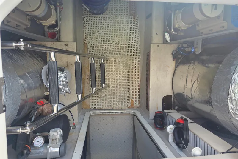 Slide: The Image of Engine room of a 2002 Sea Ray 560 Sedan Bridge with visible components and ladder. - 122