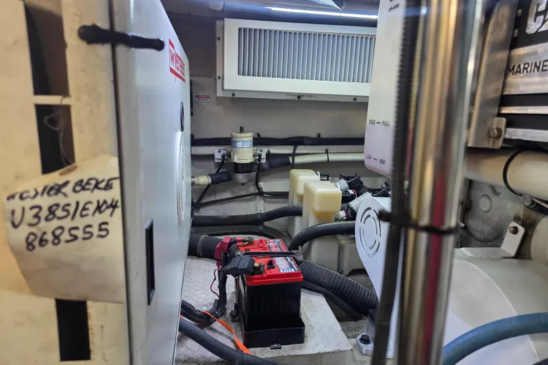Slide: The Image of Engine room of 2002 Sea Ray 560 Sedan Bridge with visible battery and wiring. - 124