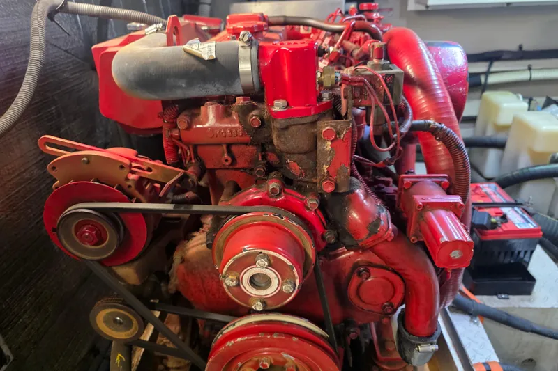 Slide: The Image of Engine of a 2002 Sea Ray 560 Sedan Bridge, featuring red components and belts. - 128