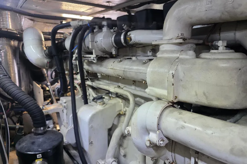 Slide: The Image of Engine room of 2002 Sea Ray 560 Sedan Bridge yacht, showcasing complex machinery and piping. - 132