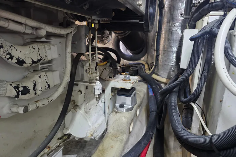 Slide: The Image of Engine room of 2002 Sea Ray 560 Sedan Bridge with visible cables and machinery. - 143