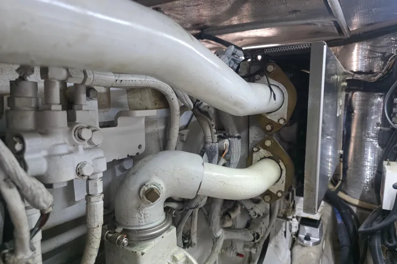 Slide: The Image of Engine compartment of a 2002 Sea Ray 560 Sedan Bridge yacht, showcasing pipes and components. - 145
