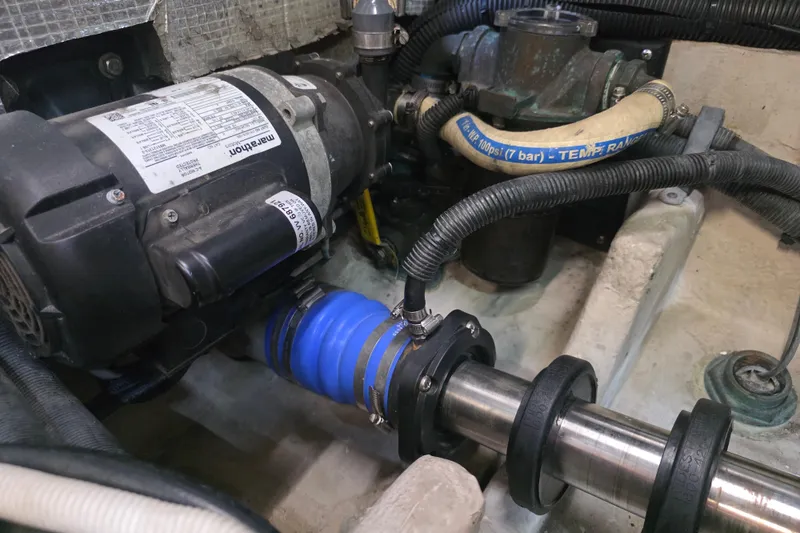 Slide: The Image of Engine compartment of a 2002 Sea Ray 560 Sedan Bridge, featuring mechanical components and hoses. - 155