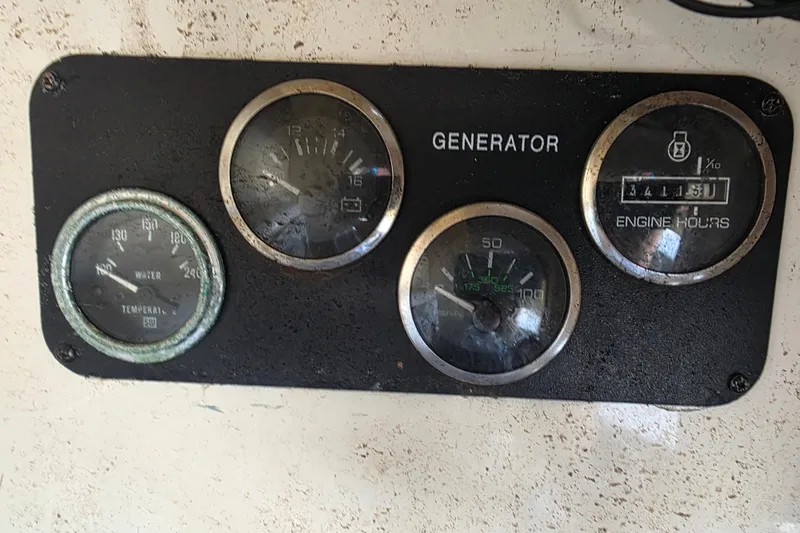 Slide: The Image of Instrument panel of a 2002 Sea Ray 560 Sedan Bridge generator with gauges. - 176