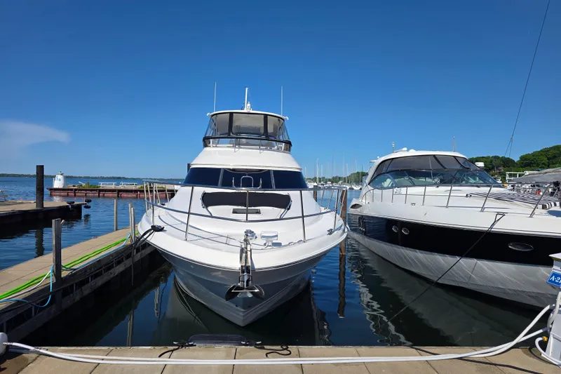 Slide: The Image of 2002 Sea Ray 560 Sedan Bridge yacht docked at marina on a sunny day. - 19