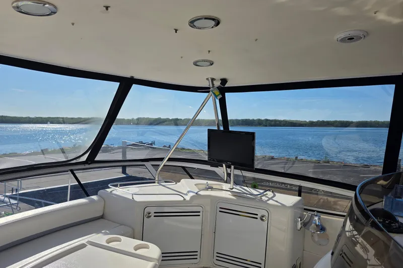 Slide: The Image of Interior view of 2002 Sea Ray 560 Sedan Bridge yacht with panoramic water view. - 31