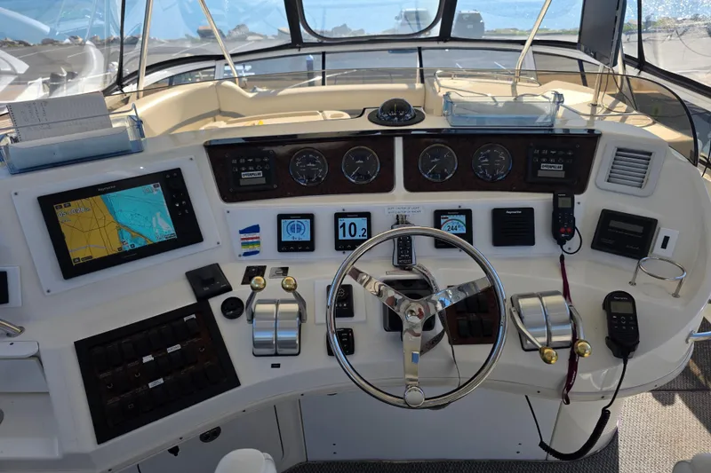 Slide: The Image of Cockpit of 2002 Sea Ray 560 Sedan Bridge with navigation and control instruments. - 47