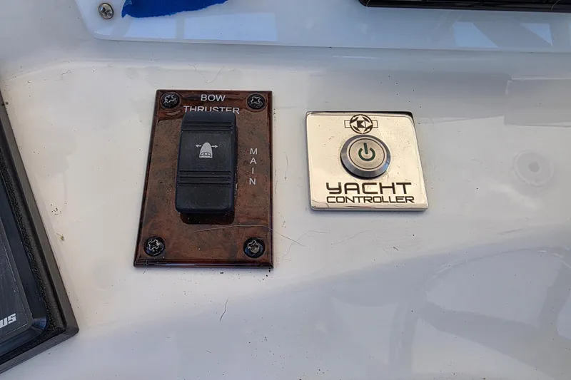Slide: The Image of Control panel on a 2002 Sea Ray 560 Sedan Bridge yacht, featuring yacht controller and bow thruster switch. - 53