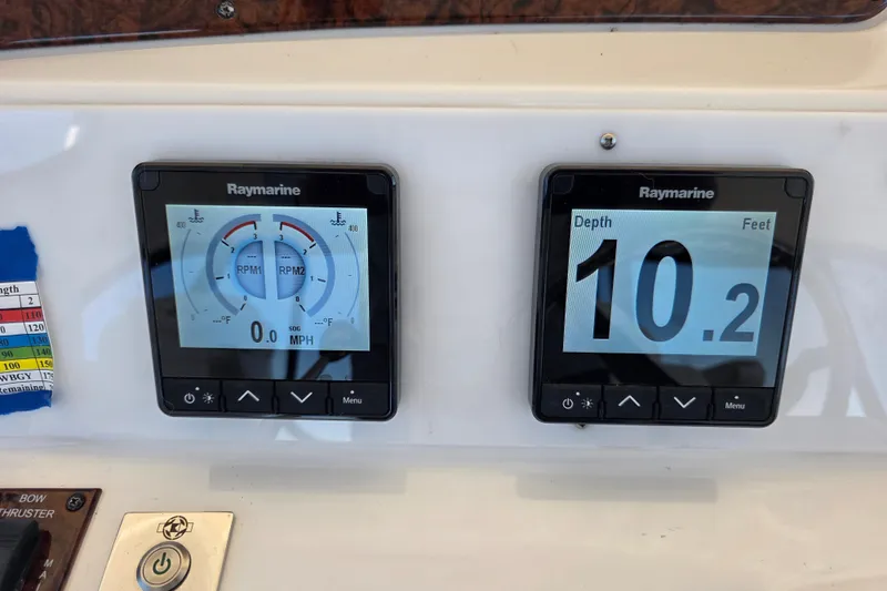 Slide: The Image of Raymarine displays on 2002 Sea Ray 560 Sedan Bridge showing RPM and depth readings. - 61