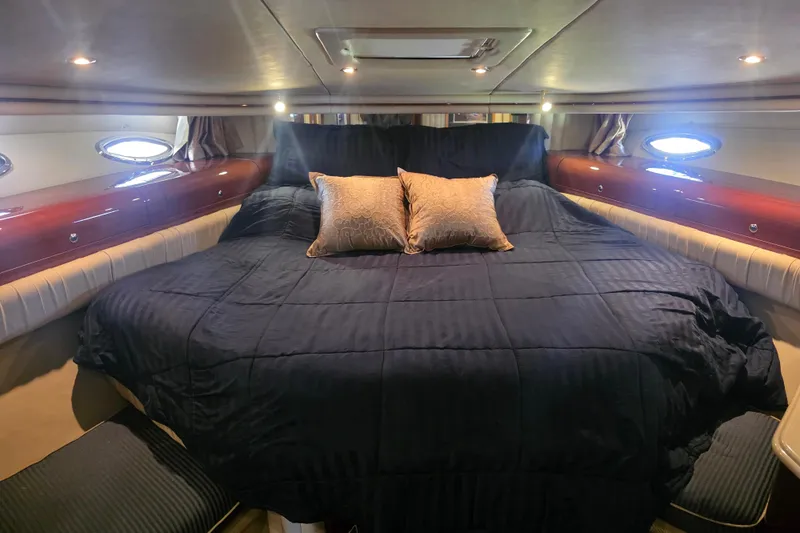 Slide: The Image of Luxurious bedroom interior of 2002 Sea Ray 560 Sedan Bridge yacht with elegant bedding. - 71