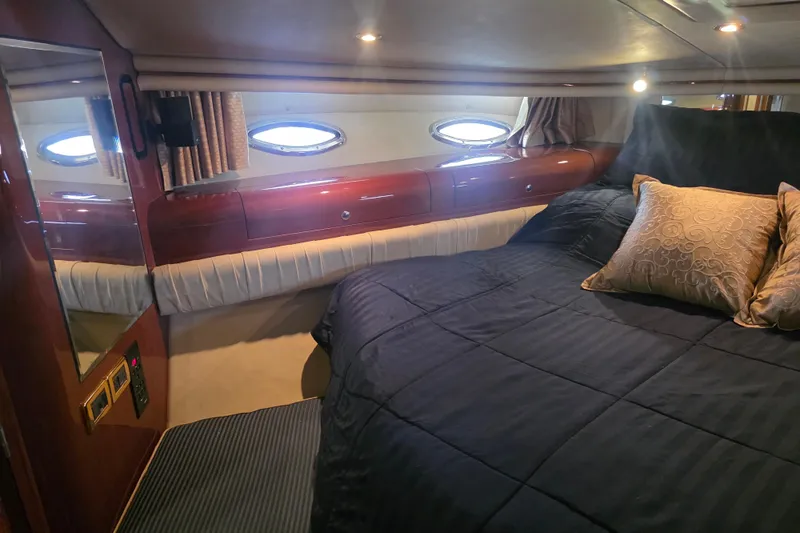 Slide: The Image of Luxurious cabin interior of 2002 Sea Ray 560 Sedan Bridge yacht with elegant bedding. - 72