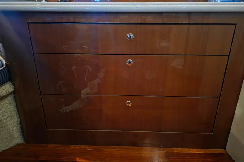 Slide: The Image of Wooden cabinet with three drawers on a 2002 Sea Ray 560 Sedan Bridge yacht. - 74