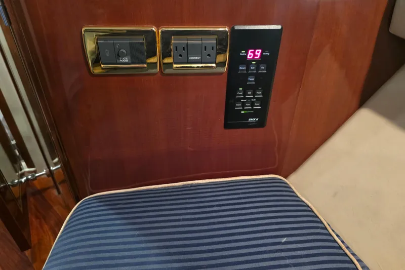 Slide: The Image of Control panel and outlets on 2002 Sea Ray 560 Sedan Bridge yacht interior. - 79