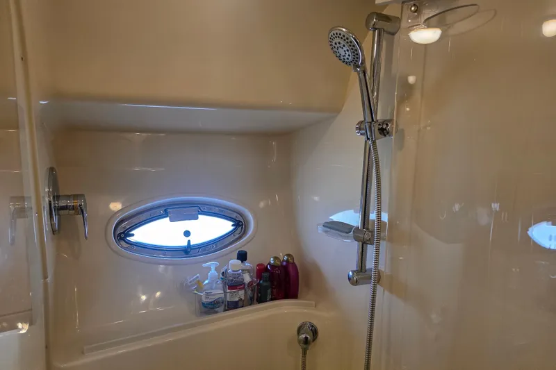 Slide: The Image of Luxurious bathroom in 2002 Sea Ray 560 Sedan Bridge yacht with shower and porthole. - 84