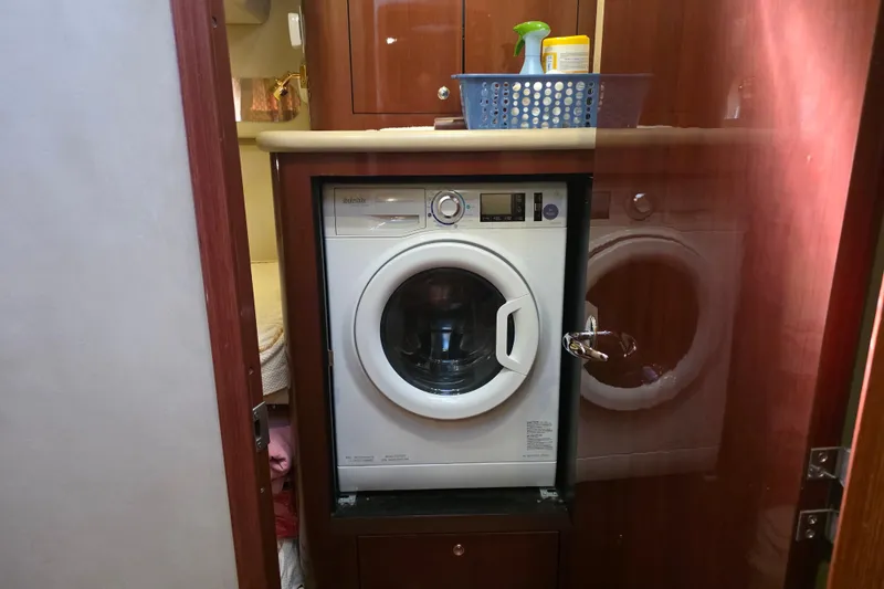 Slide: The Image of Laundry area with washer inside 2002 Sea Ray 560 Sedan Bridge yacht. - 94